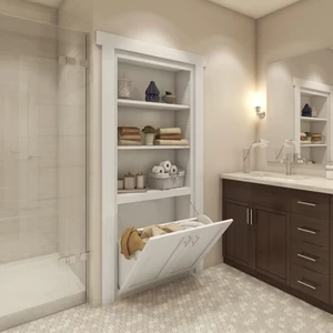 Bathroom built-in shelving with a hidden tilt-out laundry hamper door below the shelves.