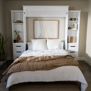 White vertical Murphy bed with built-in side shelves and drawers, shown open in a bright bedroom.