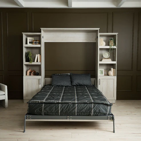 Murphy Door® wall bed unit with light wood bookcase surround, dark gray bedding, and displayed against olive paneled wall.