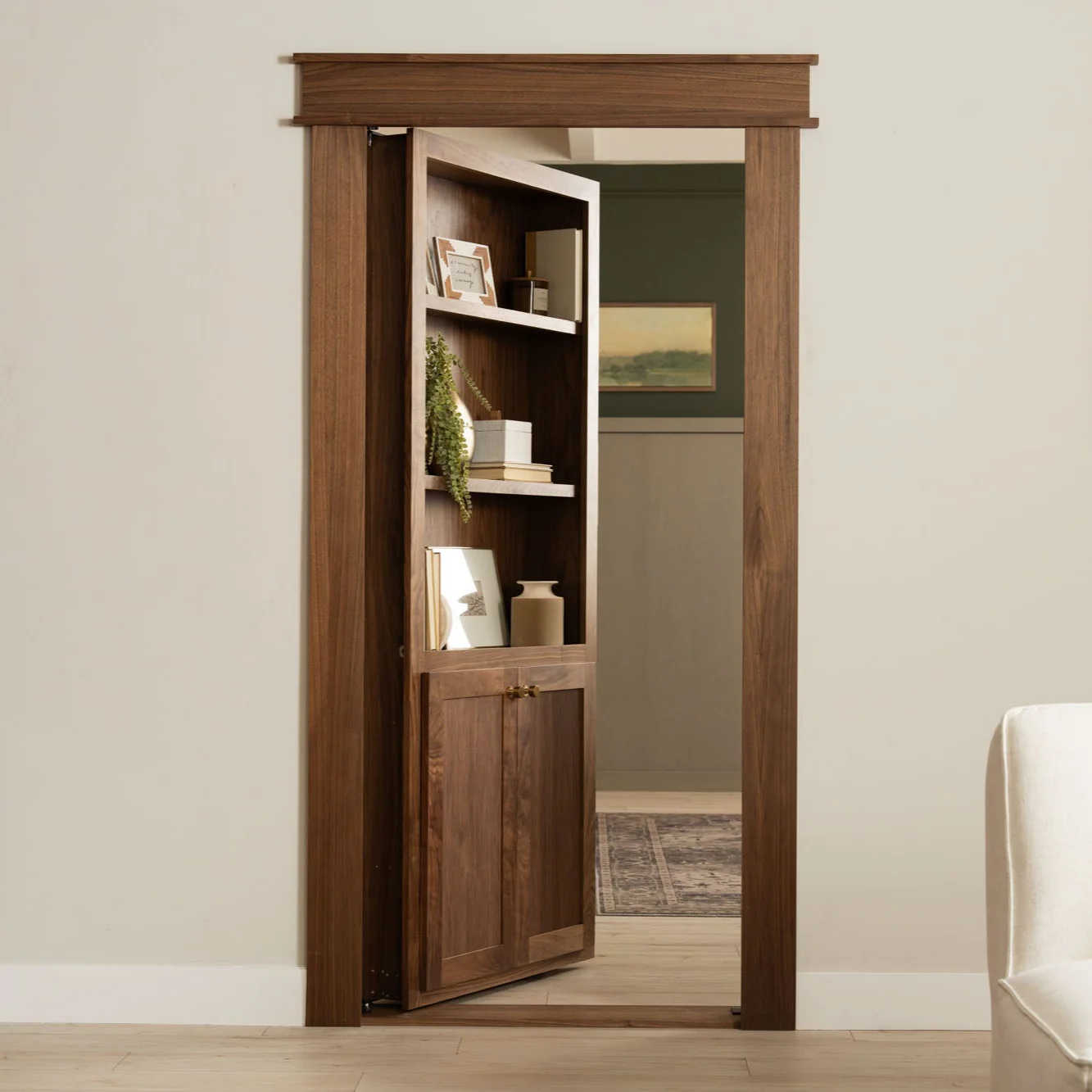Murphy Door® walnut bookcase hidden door showing open configuration with decorative shelving and cabinet storage leading to another room.
